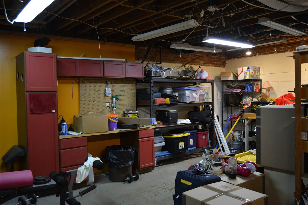 3123 Childers Street Raleigh, NC 27612 - Photo 18 of 25 Basement workshop with built in cabinets. Work Shop
