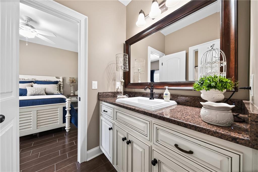 611 Padgetts Road Opelika, AL 36804 - Photo 35 of 64 Bathroom vanity with a brown granite countertop, an undermount sink, and a dark bronze faucet