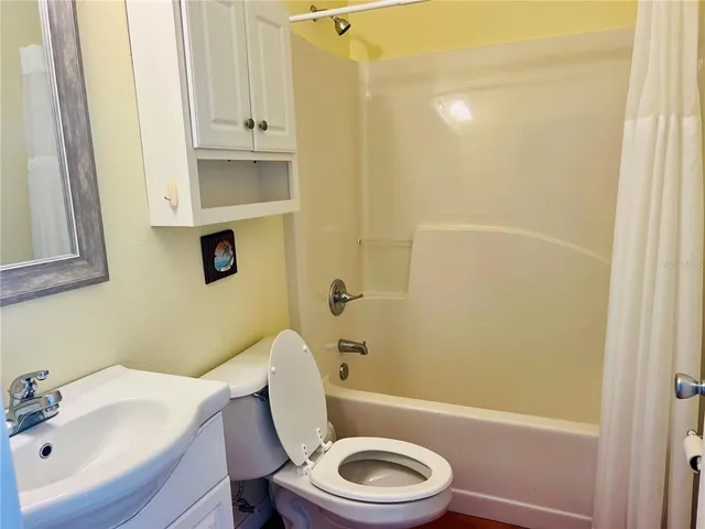 a white toilet sitting next to a bathroom sink