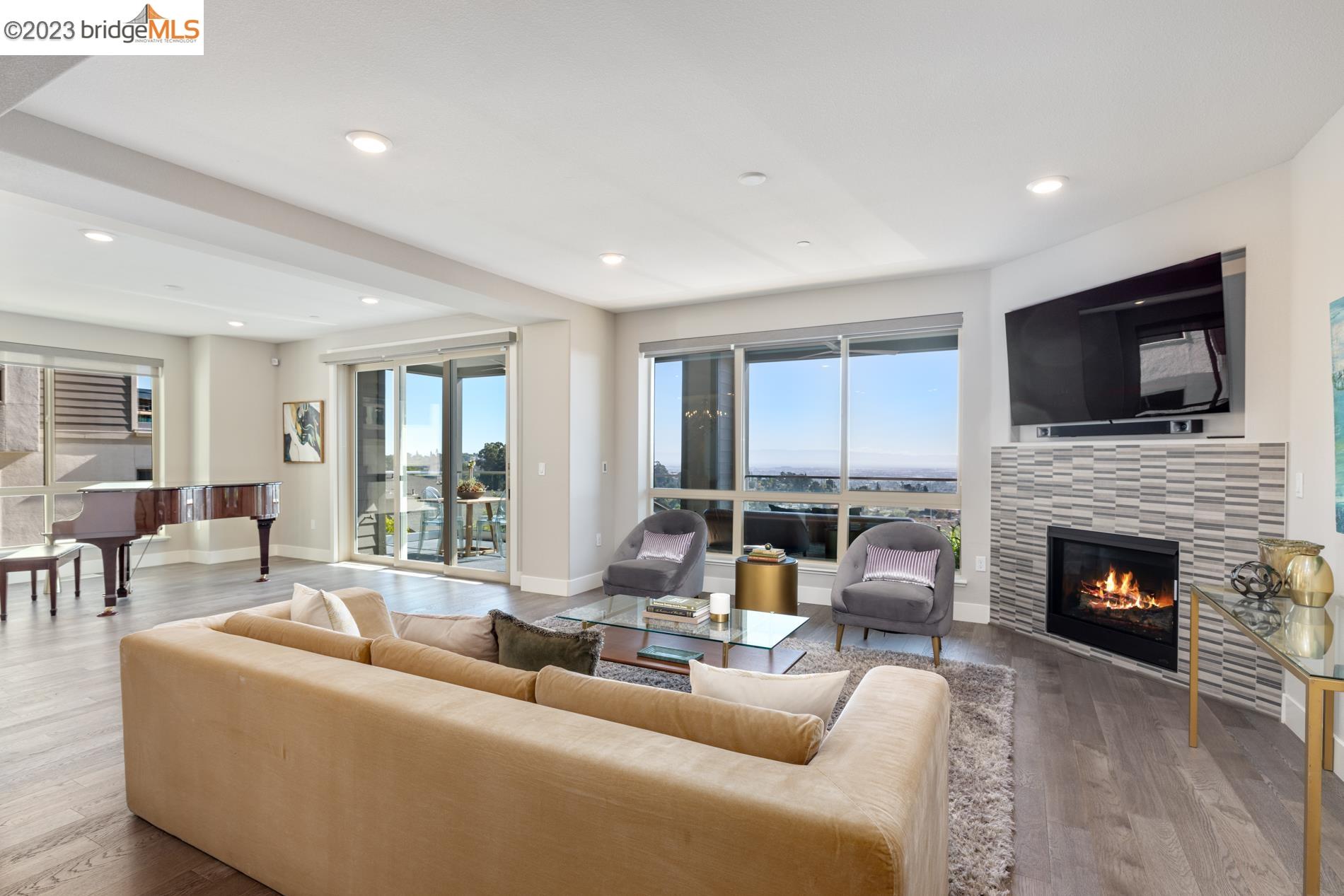 6721 Skyview Drive Oakland, CA 94605 - Photo 1 of 1 a living room with furniture fireplace and a flat screen tv