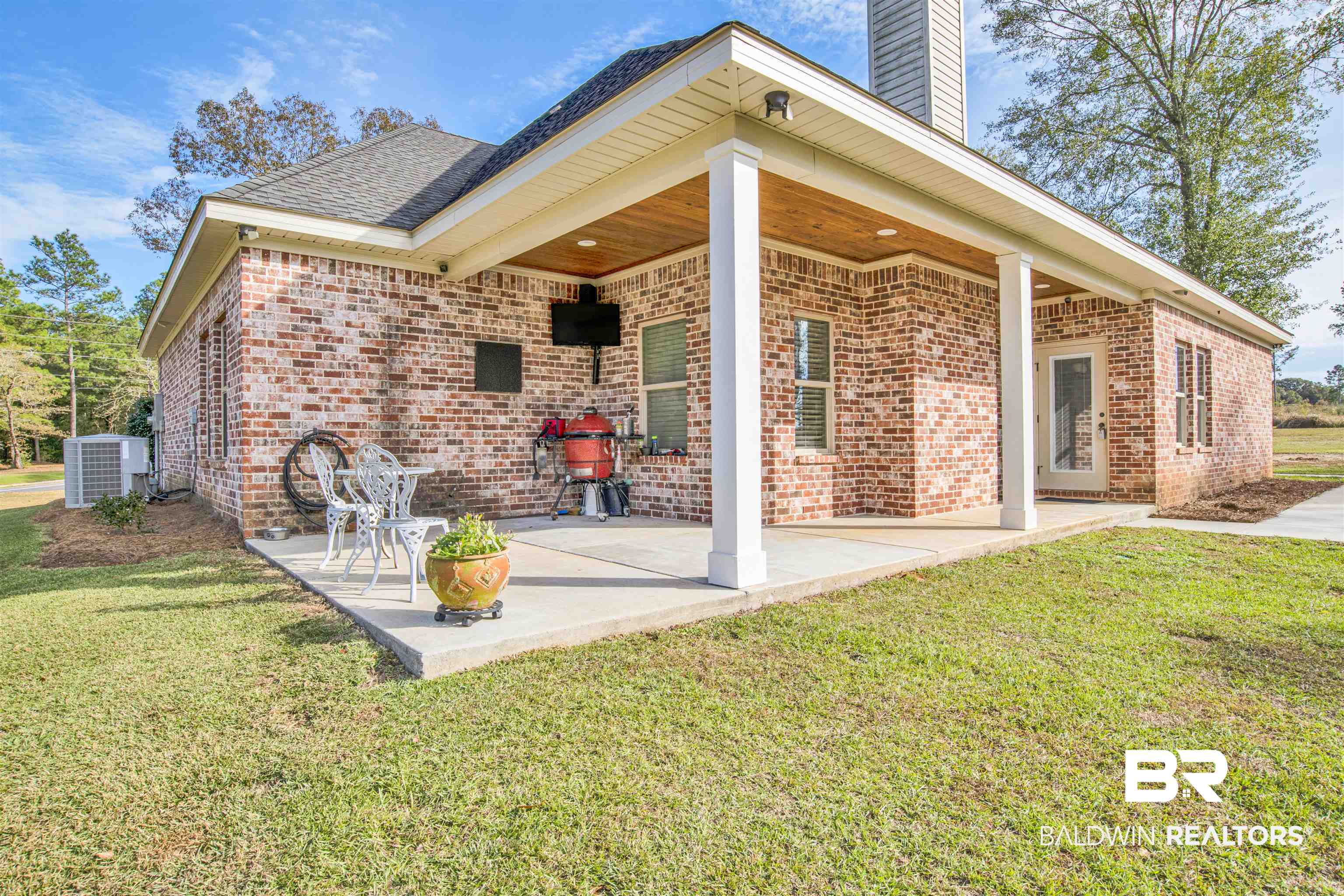 2440 Johnson Road West Mobile, AL 36695 - Photo 36 of 40 Back of property with central air condition unit, a patio area, and a lawn