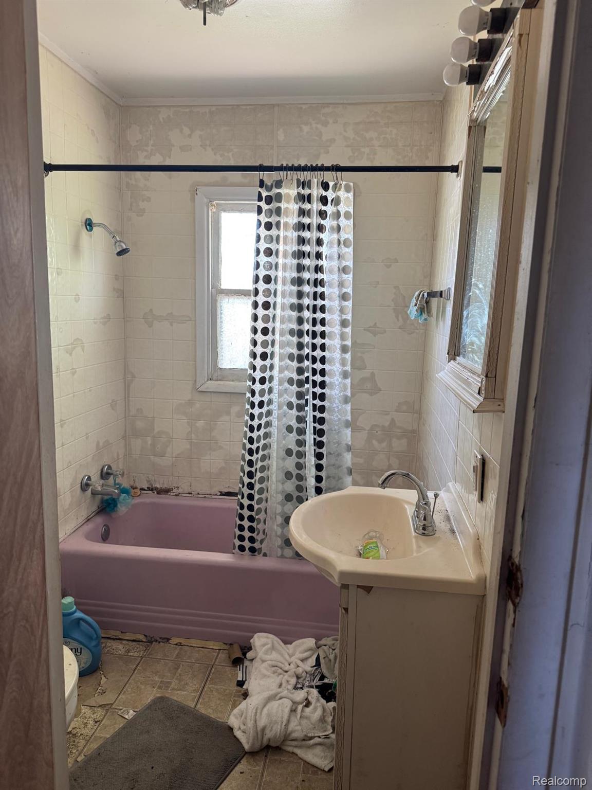 1610 Kent Street Flint, MI 48503 - Photo 9 of 11 Full bathroom featuring shower / bath combination with curtain, vanity, and light tile patterned floors