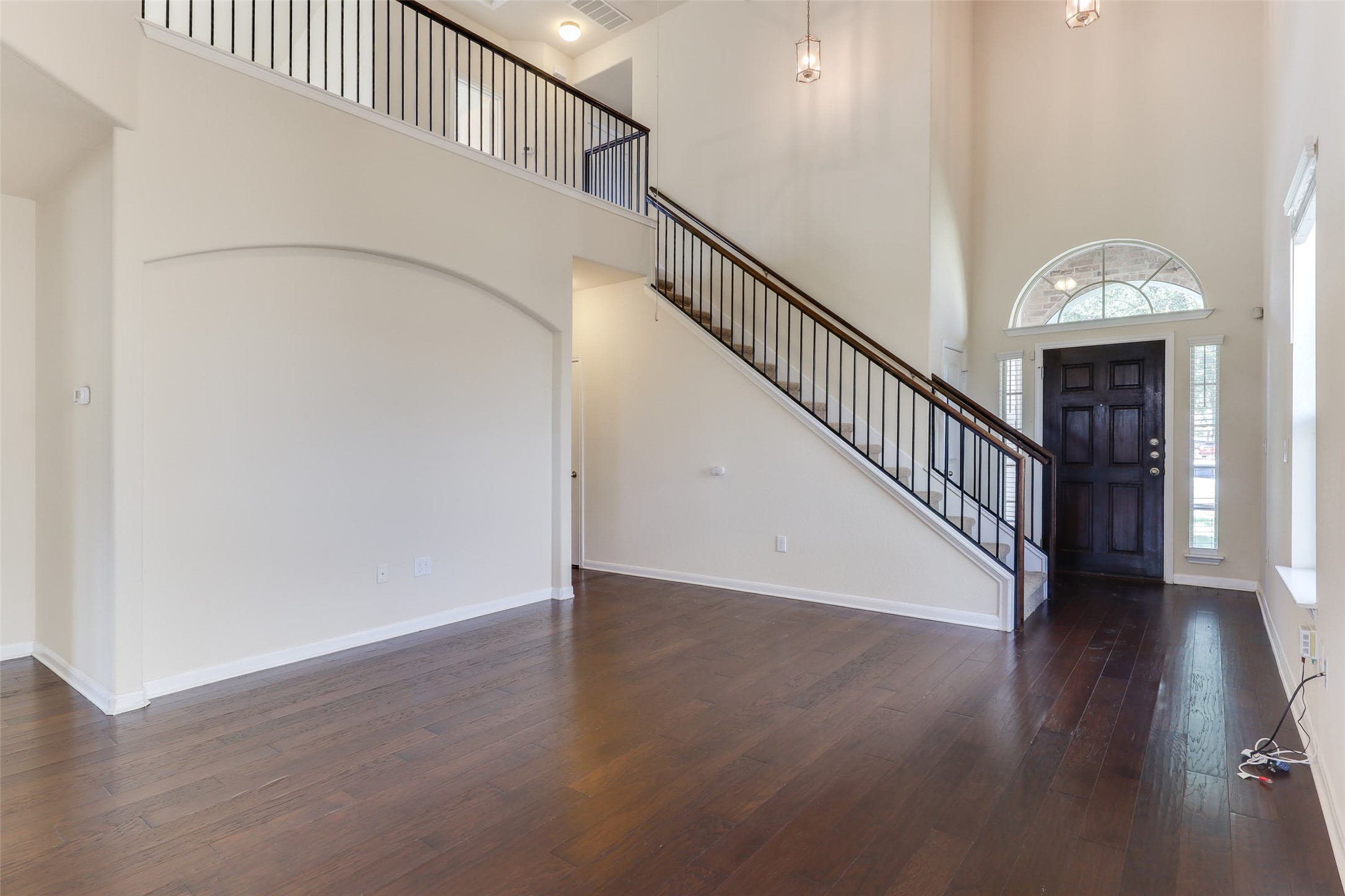 18705 Moreto Loop Pflugerville, TX 78660 - Photo 5 of 21 A grand entryway features rich hardwood floors, a sweeping staircase, and towering ceilings.