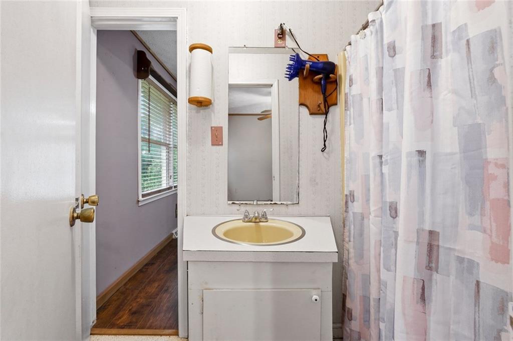 399 Donahoo Road Southeast Silver Creek, GA 30173 - Photo 16 of 22 a bathroom with a sink and mirror