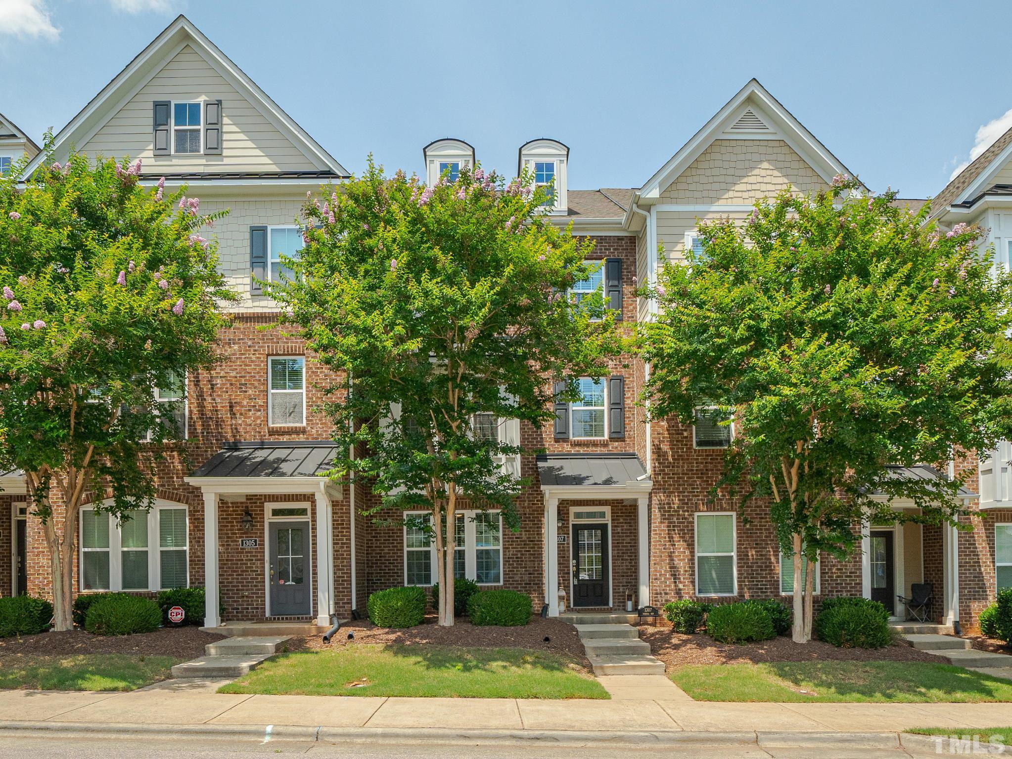 1307 Rodessa Run Raleigh, NC 27607 - Photo 1 of 36 a front view of a house with a yard and large trees