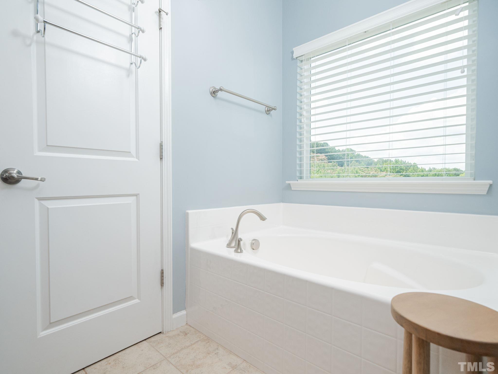 1307 Rodessa Run Raleigh, NC 27607 - Photo 25 of 36 a bathroom with a tub a toilet and a sink