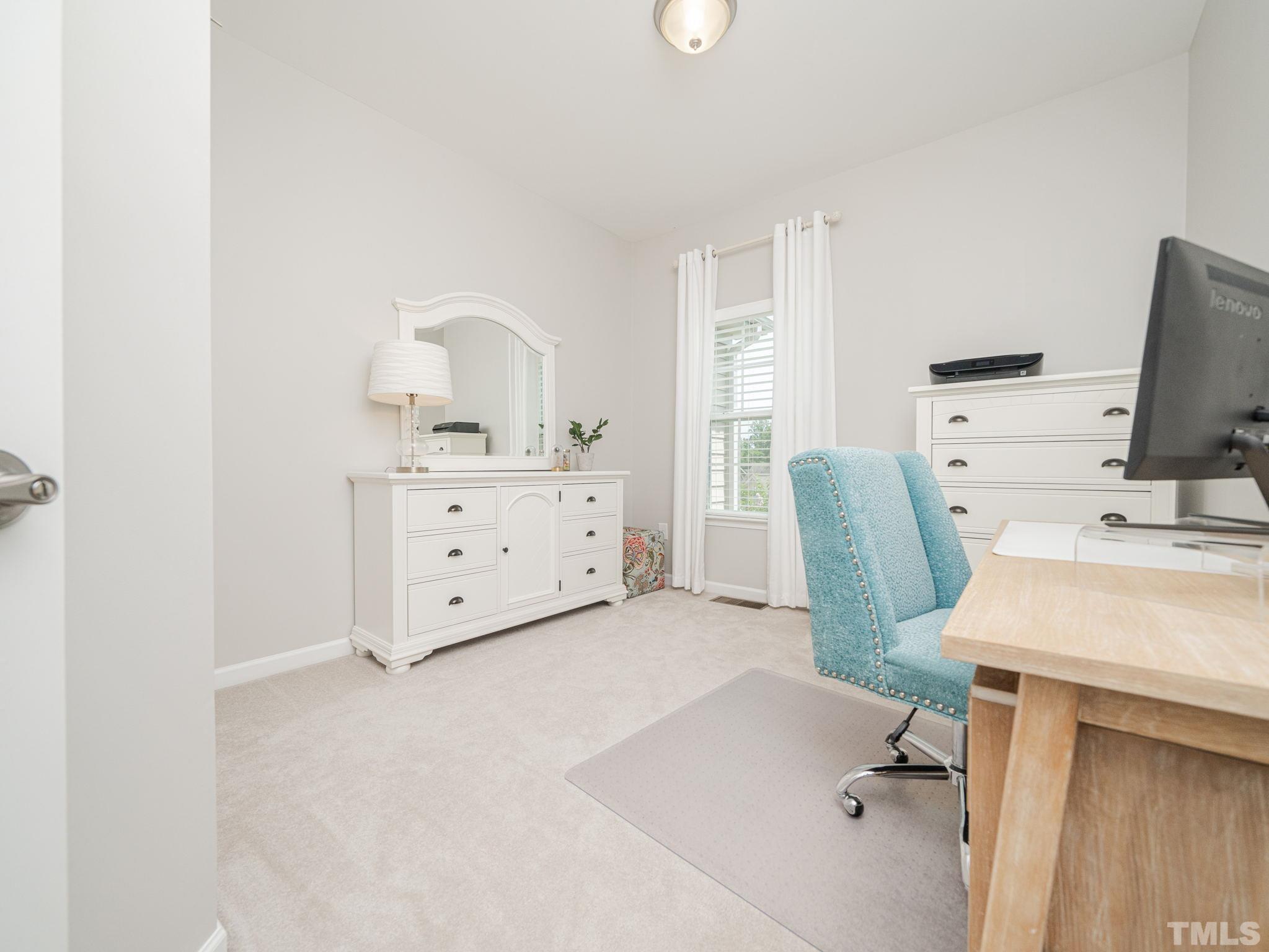 1307 Rodessa Run Raleigh, NC 27607 - Photo 27 of 36 a spacious bedroom with a bed and a workspace