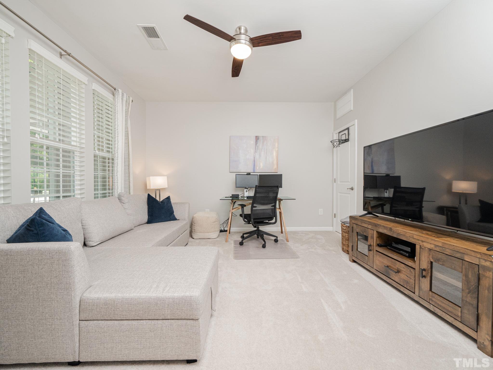1307 Rodessa Run Raleigh, NC 27607 - Photo 5 of 36 a bedroom with furniture and a large window