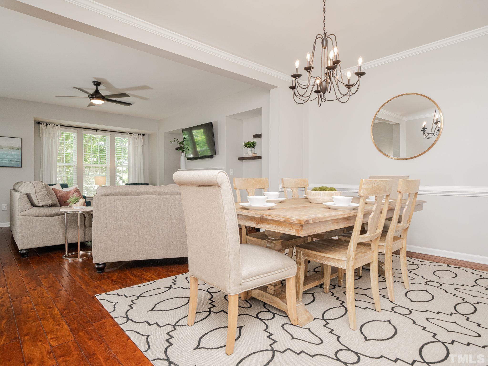 1307 Rodessa Run Raleigh, NC 27607 - Photo 8 of 36 a view of a dining room with furniture a chandelier and wooden floor
