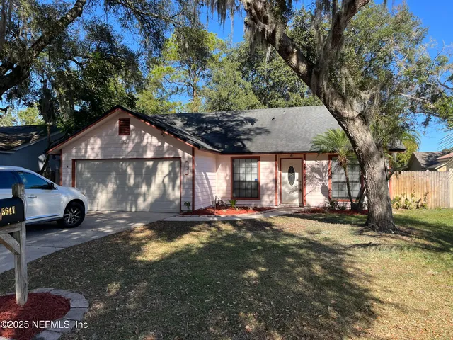 a view of a house with a yard covered with snow in the background