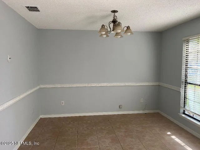 a view of a room with a window and ceiling fan