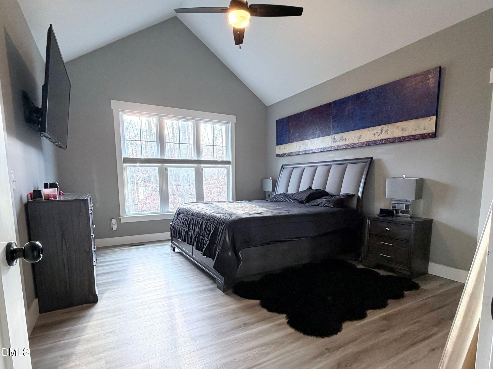 55 Running Deer Path Timberlake, NC 27583 - Photo 12 of 29 a bedroom with a bed and a flat tv screen on the dresser