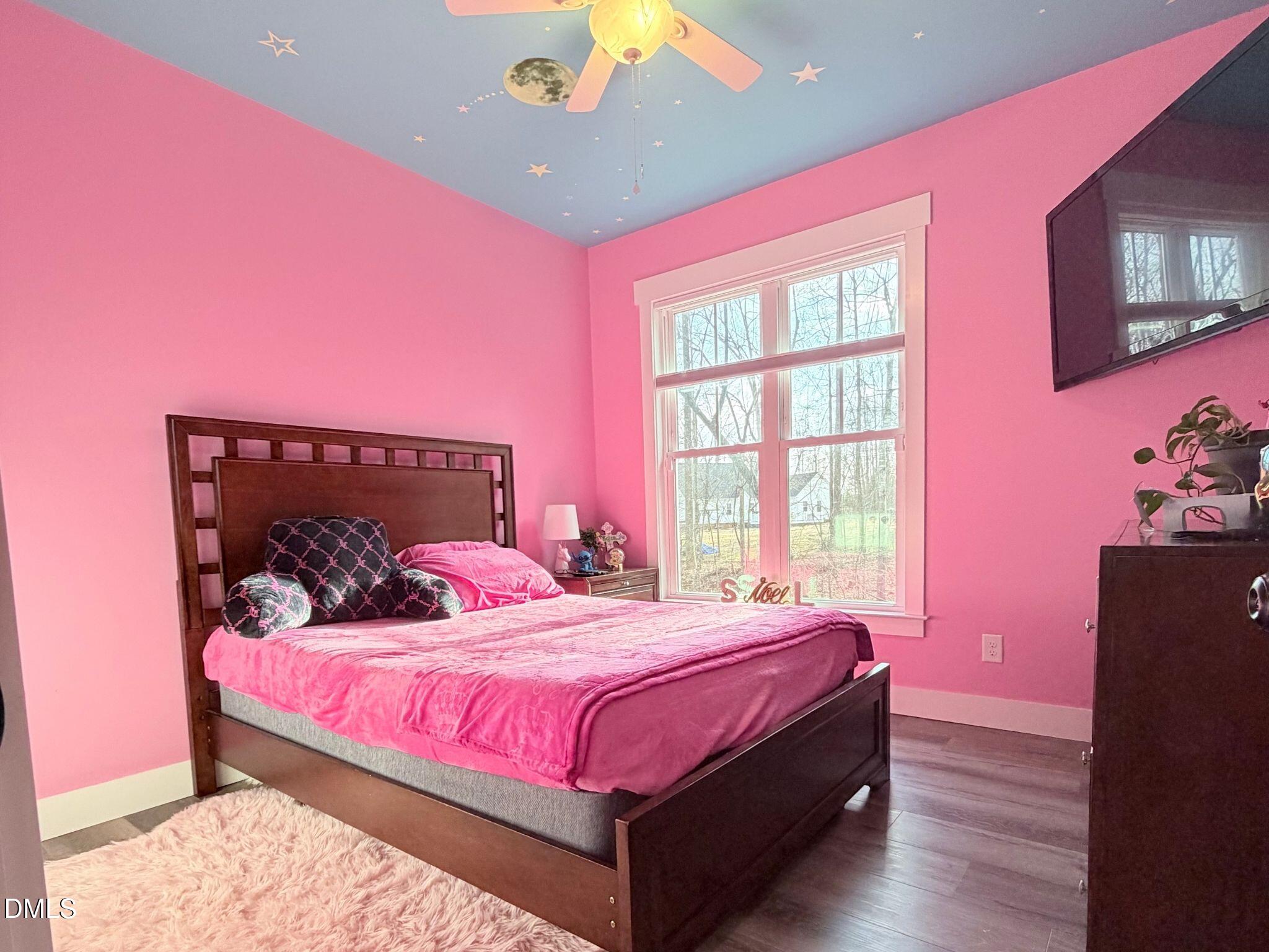 55 Running Deer Path Timberlake, NC 27583 - Photo 15 of 29 a bedroom with a bed and a chandelier