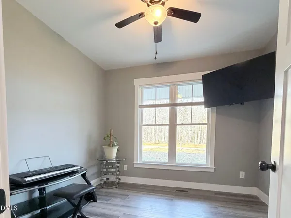 a room with a window and wooden floor