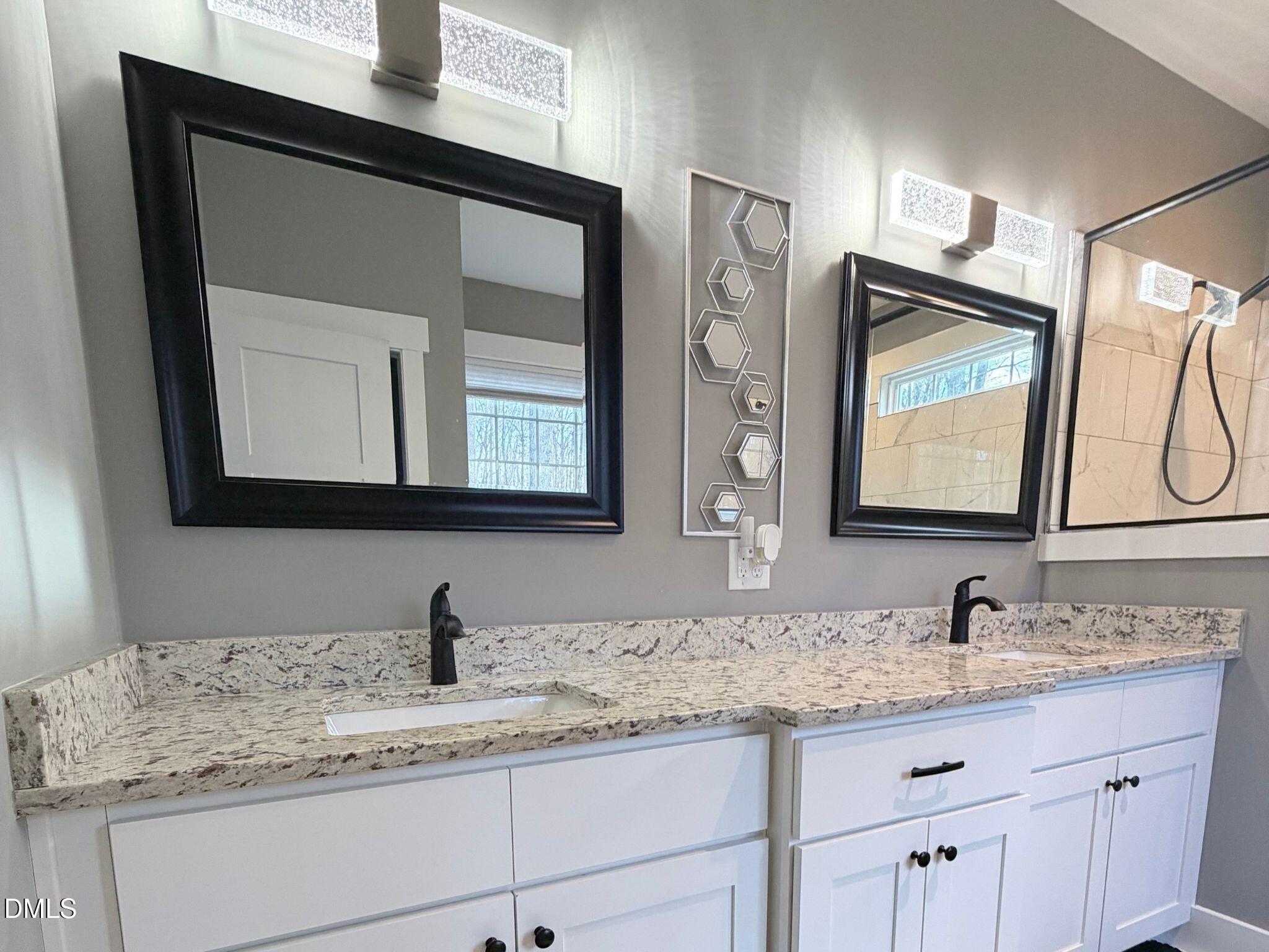 55 Running Deer Path Timberlake, NC 27583 - Photo 18 of 29 a bathroom with a granite countertop double vanity sink and mirror