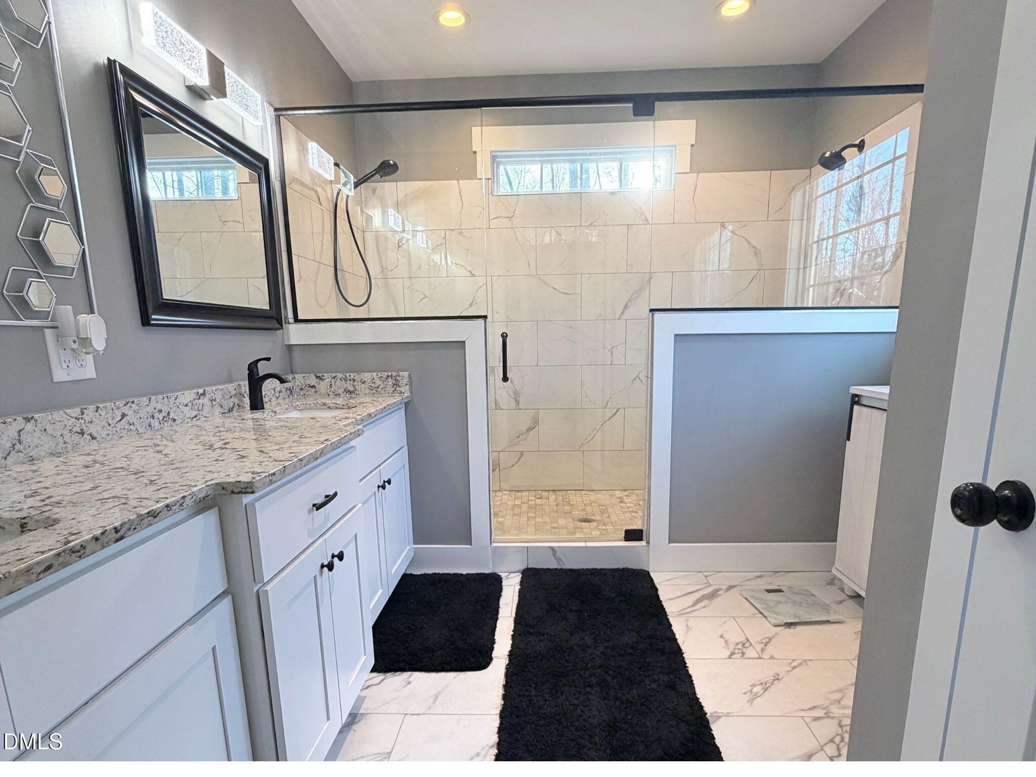 55 Running Deer Path Timberlake, NC 27583 - Photo 19 of 29 a bathroom with a double vanity sink and mirror with shower