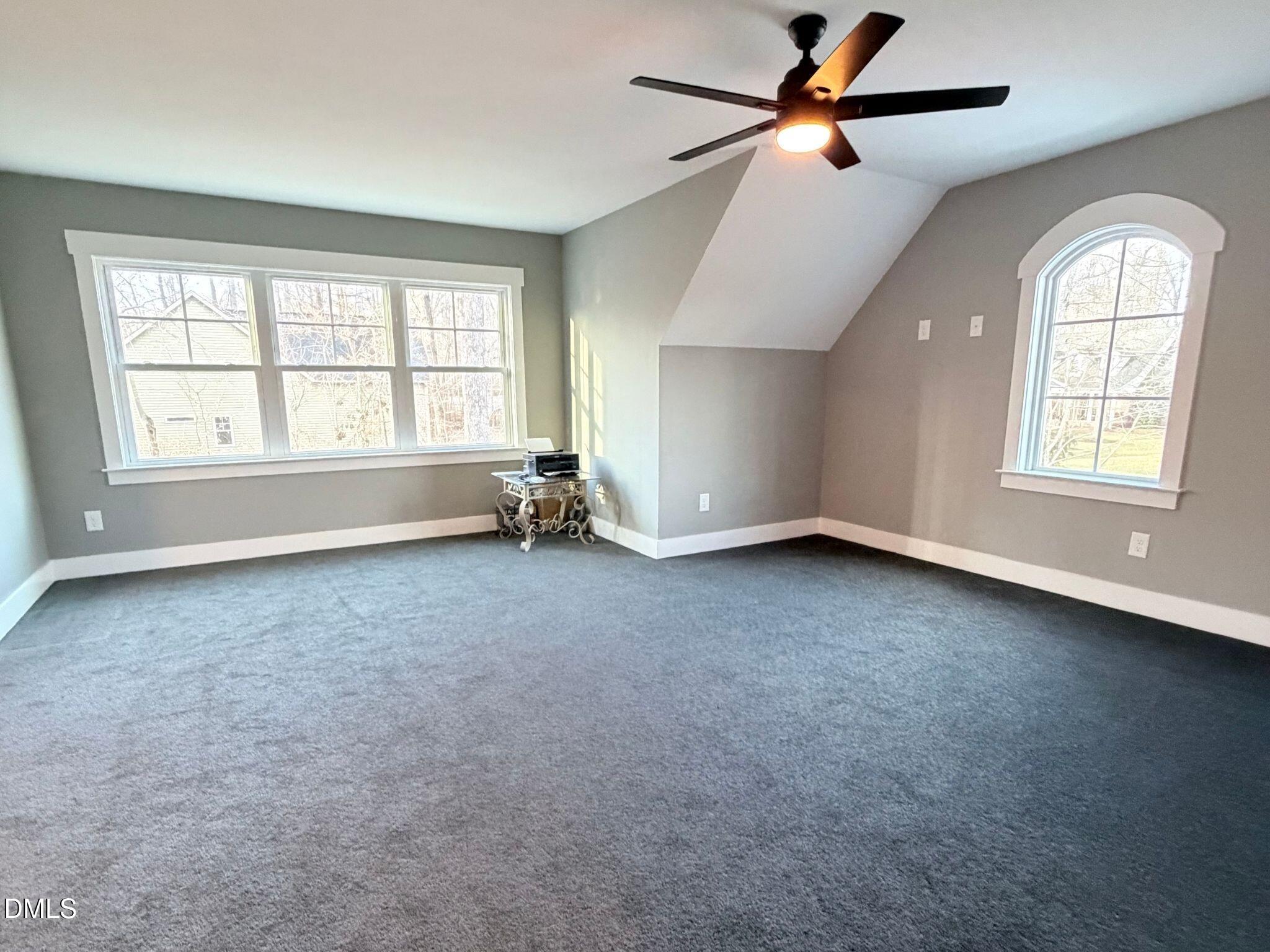 55 Running Deer Path Timberlake, NC 27583 - Photo 23 of 29 an empty room with chandelier fan and windows