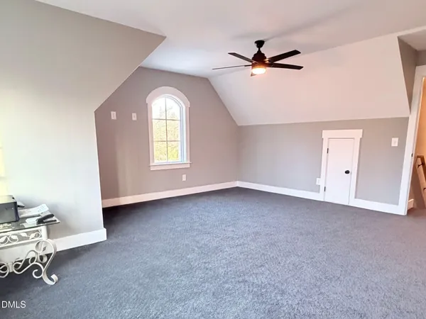 a view of a livingroom with a ceiling fan and window