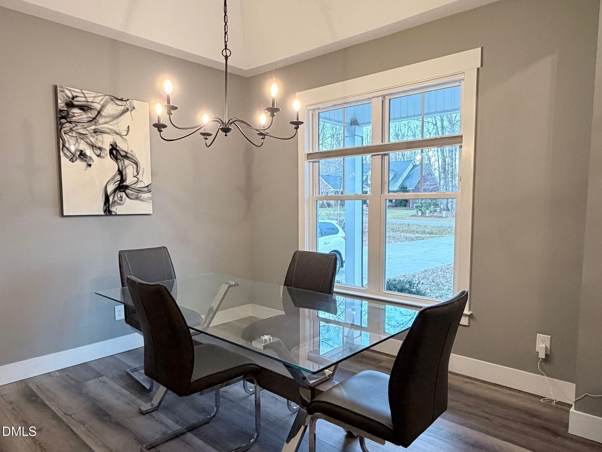 55 Running Deer Path Timberlake, NC 27583 - Photo 7 of 29 a view of a dining room with furniture window and wooden floor