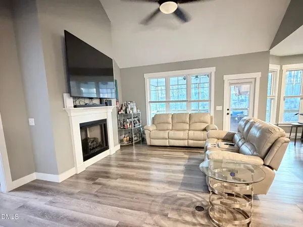 a living room with furniture a fireplace and a flat screen tv