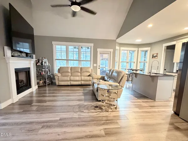 a living room with fireplace furniture and a flat screen tv