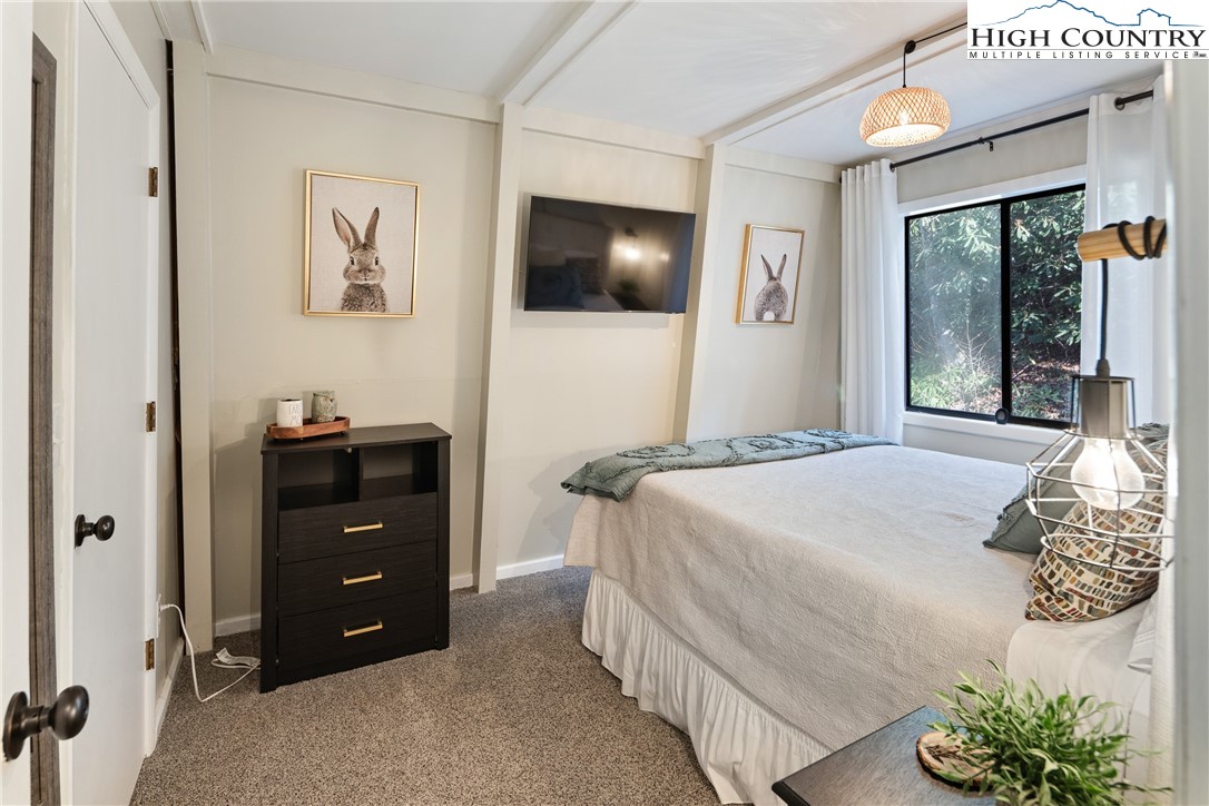 24 Creekside Court, Unit A Banner Elk, NC 28604 - Photo 11 of 24 a bedroom with a bed and a flat screen tv