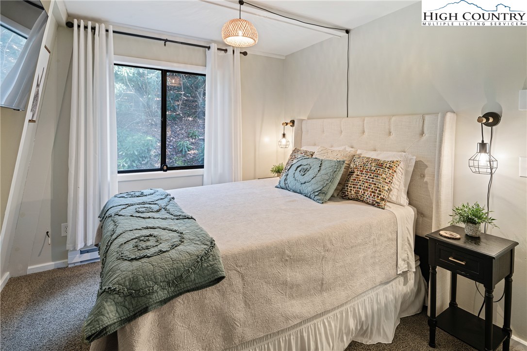 24 Creekside Court, Unit A Banner Elk, NC 28604 - Photo 12 of 24 a bedroom with a bed and a table