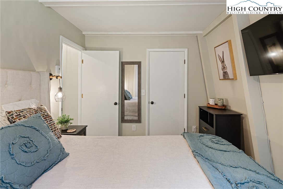 24 Creekside Court, Unit A Banner Elk, NC 28604 - Photo 13 of 24 a bedroom with a bed and a flat screen tv