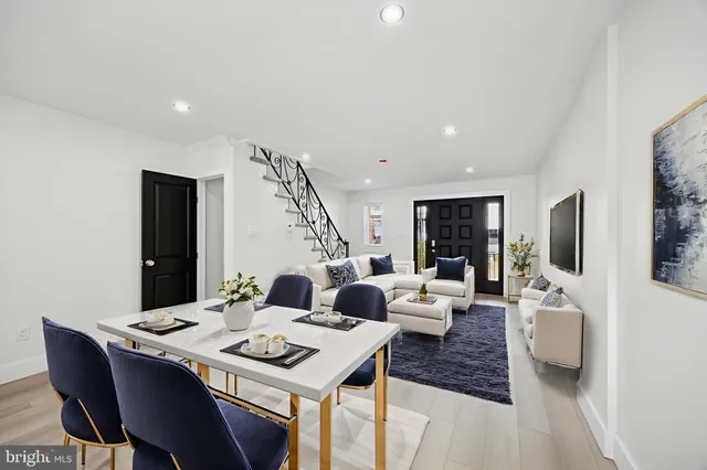 a living room with furniture a flat screen tv and a table