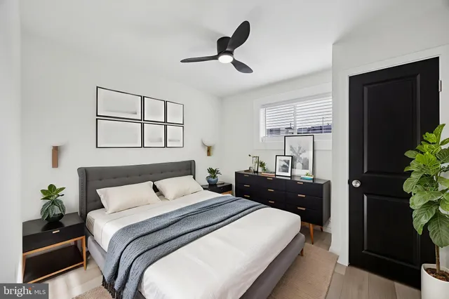 a bedroom with a bed and a potted plant