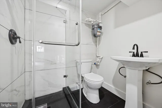 a bathroom with a toilet sink and a shower