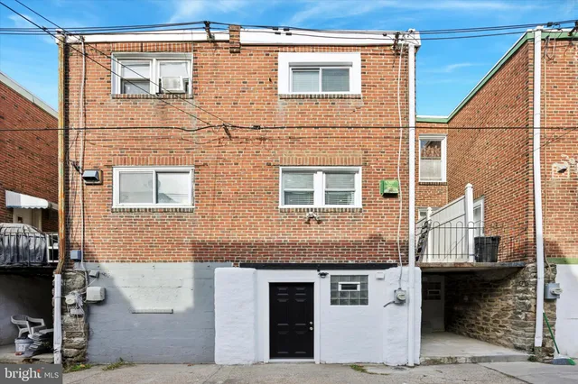 a front view of a house with large windows