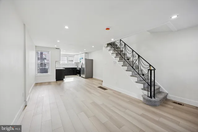 a view of entryway and hall with wooden floor