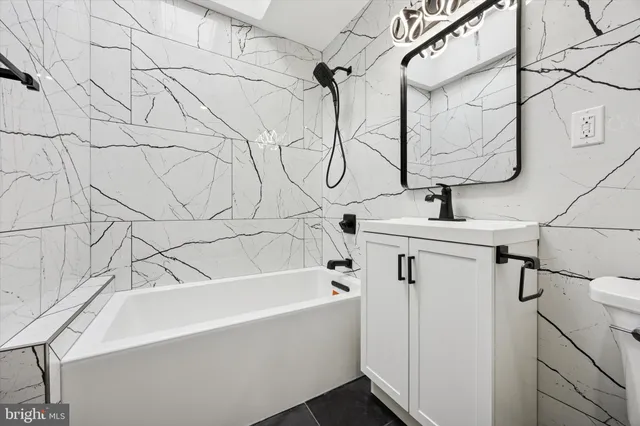 a bathroom with a bathtub and shower