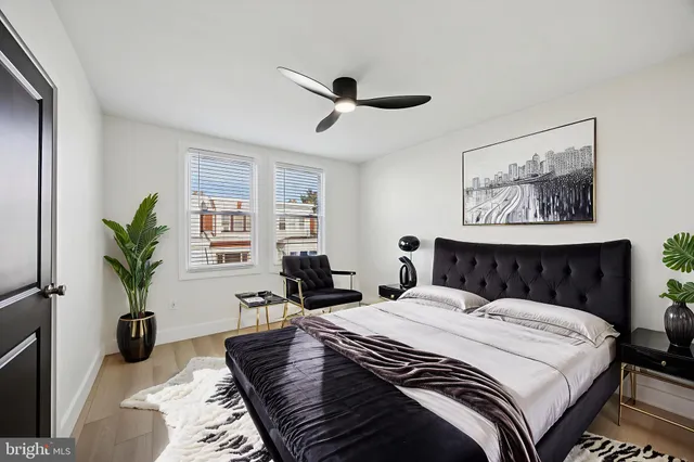 a bed room with a bed and a potted plant