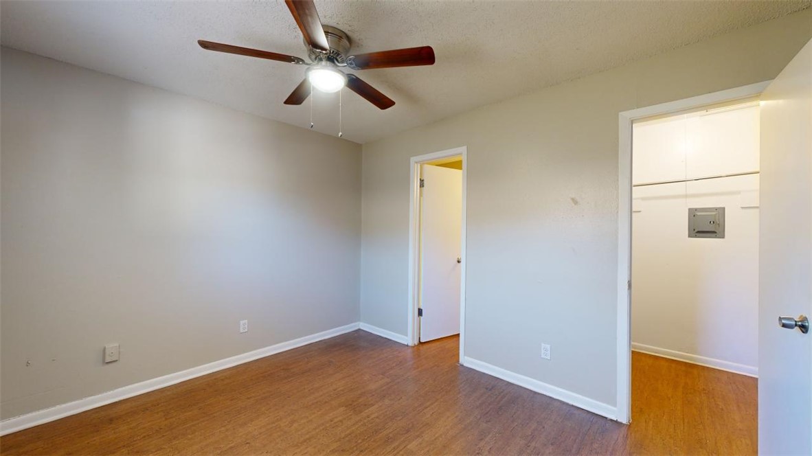 500 Foch Street, Unit 9 Bryan, TX 77801 - Photo 5 of 11 wooden floor in an empty room with a window