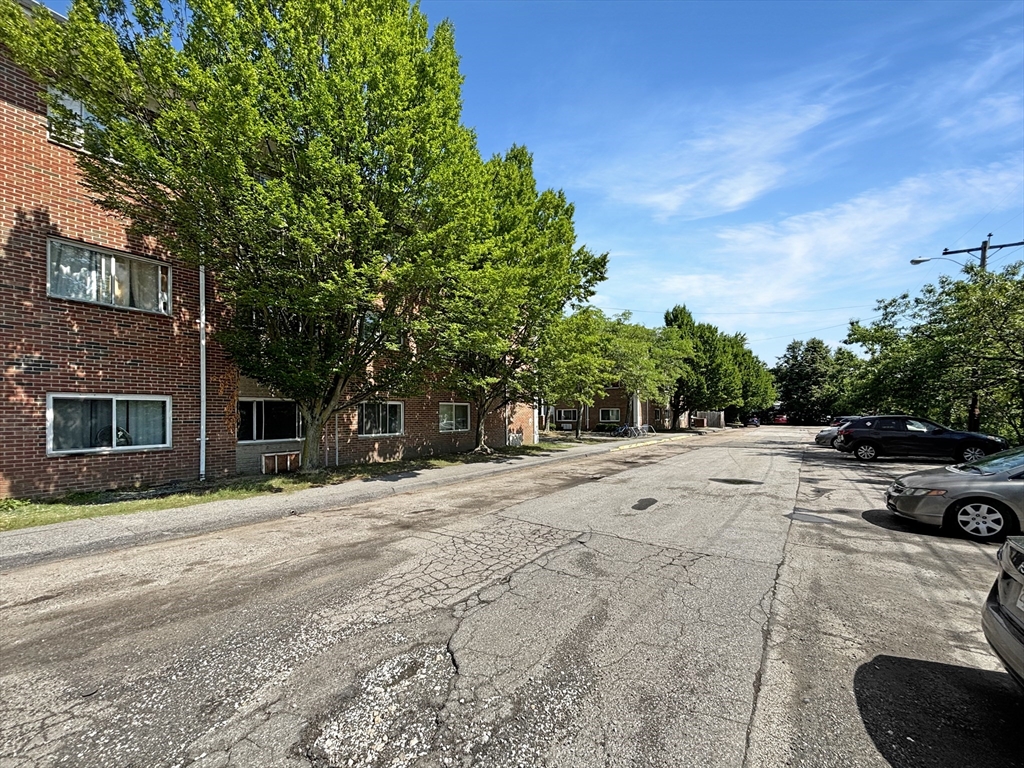 150 2nd Street, Unit 310 Framingham, MA 01702 - Photo 4 of 10 a view of road with yard and trees in the background