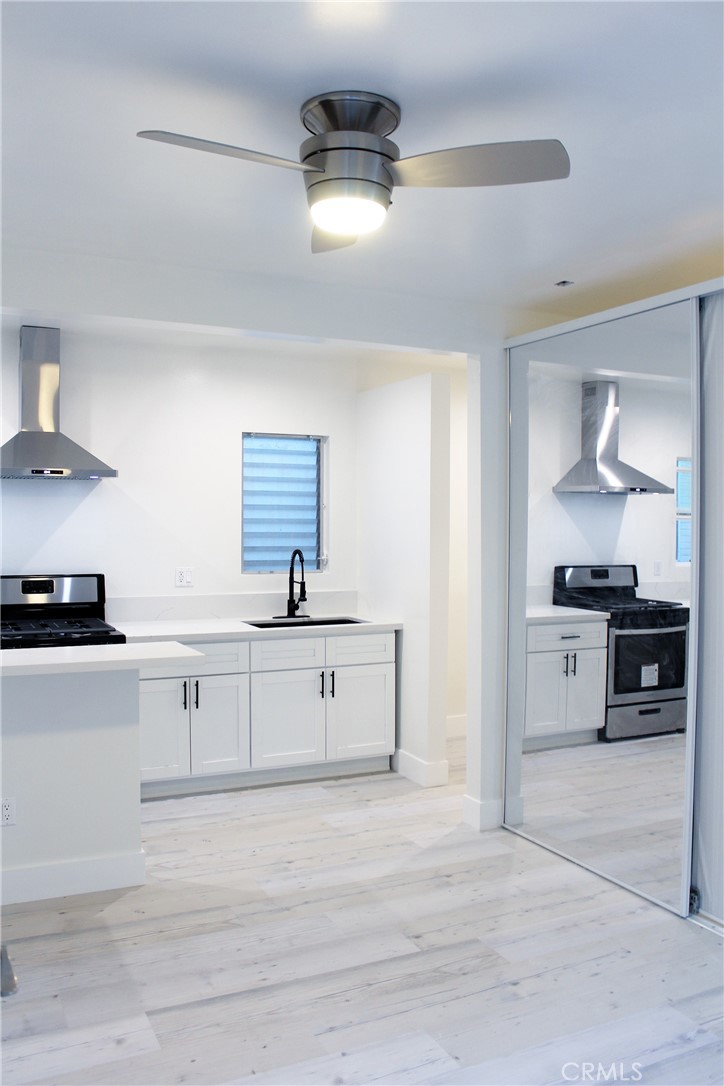 34 Ozone Avenue, Unit 2 Venice, CA 90291 - Photo 1 of 12 a large white kitchen with cabinets and appliances