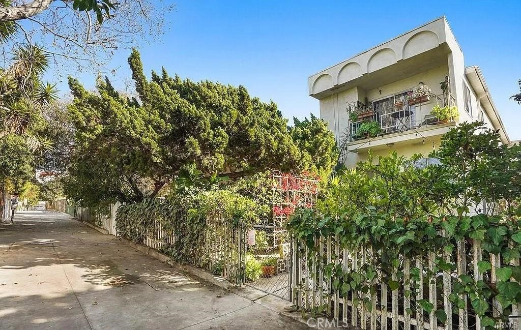 34 Ozone Avenue, Unit 2 Venice, CA 90291 - Photo 11 of 12 a yellow building with trees in front of it