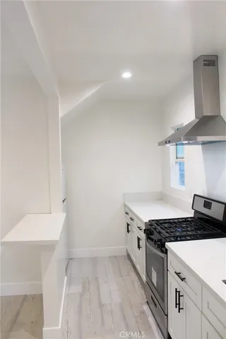 a kitchen with granite countertop a sink and a stove