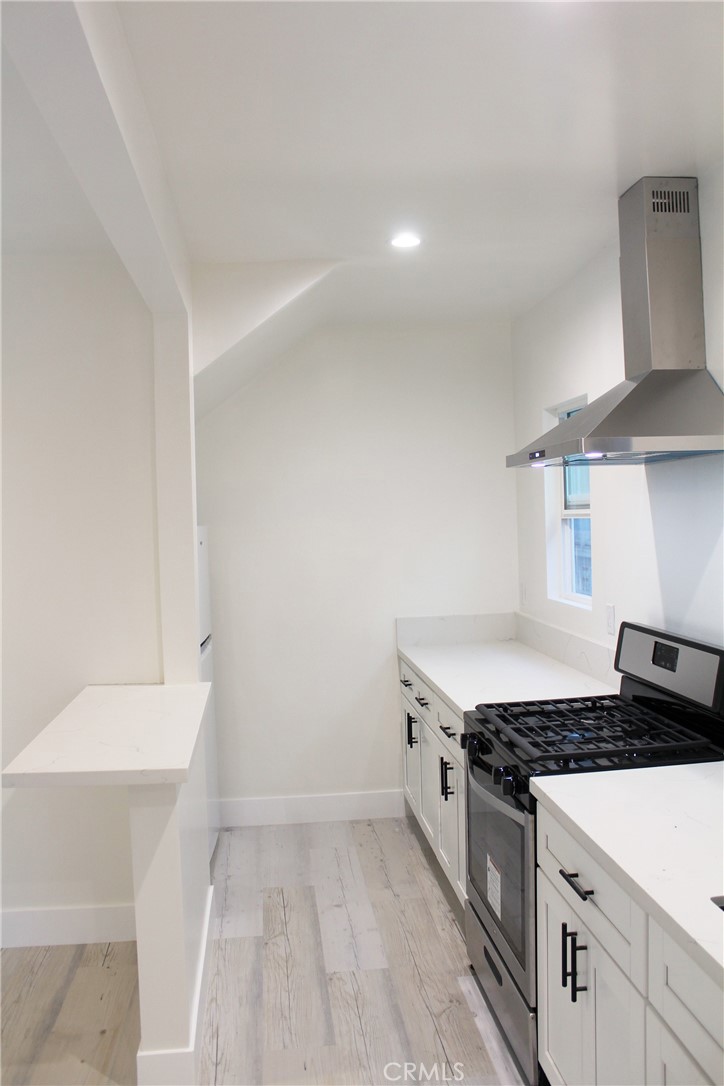 34 Ozone Avenue, Unit 2 Venice, CA 90291 - Photo 3 of 12 a kitchen with granite countertop a sink and a stove