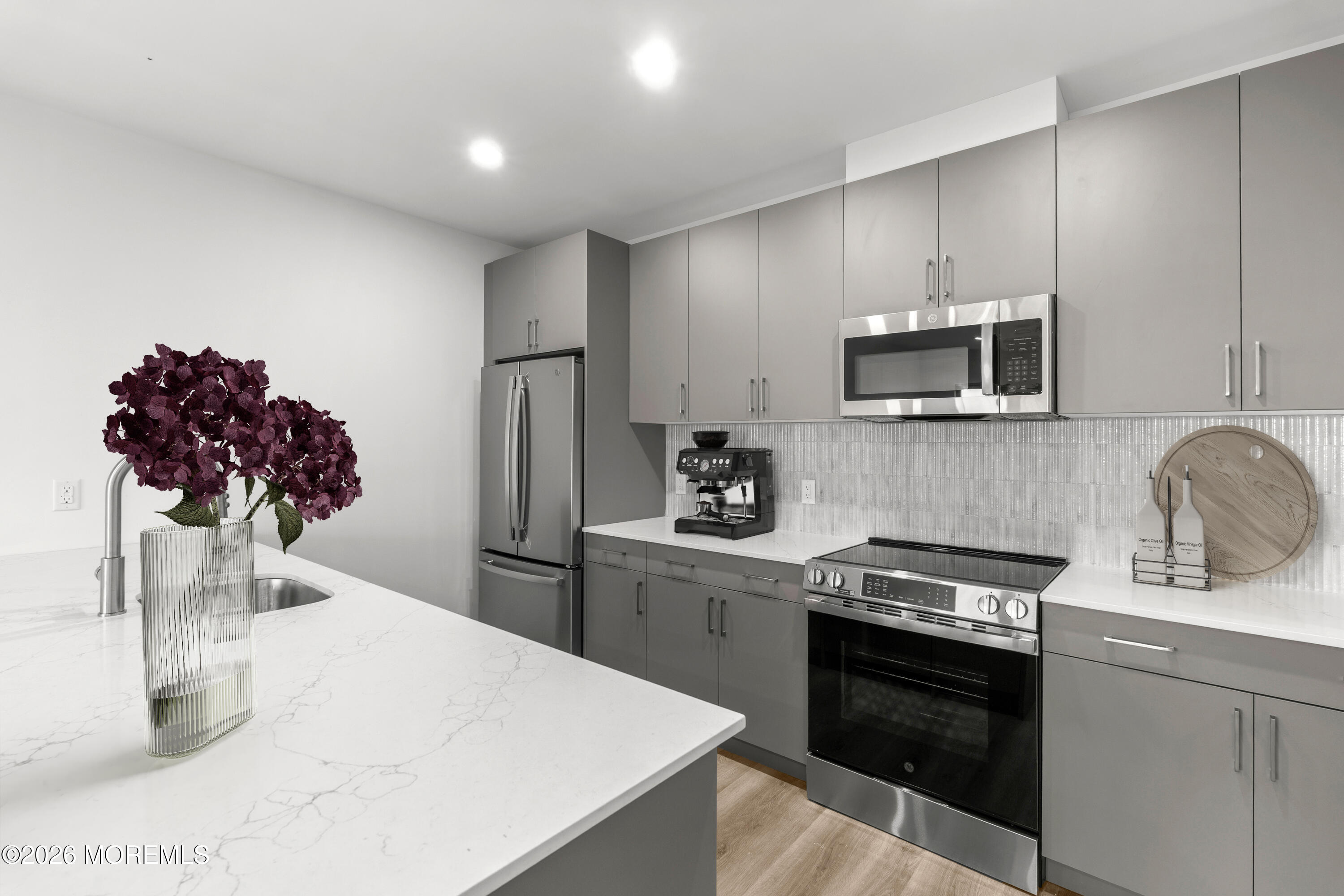 180 Morris Avenue, Unit 403 Long Branch, NJ 07740 - Photo 4 of 15 a kitchen with a sink stainless steel appliances and cabinets