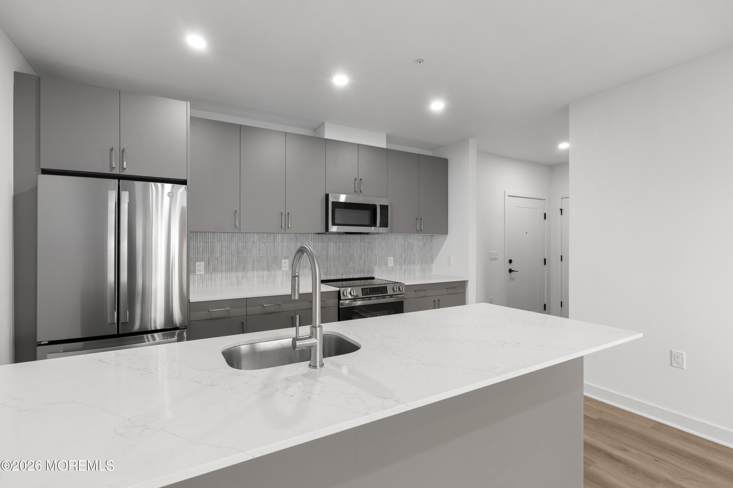 180 Morris Avenue, Unit 403 Long Branch, NJ 07740 - Photo 5 of 15 a kitchen with stainless steel appliances a refrigerator sink and microwave