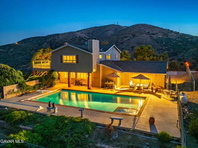 an aerial view of a house with a swimming pool