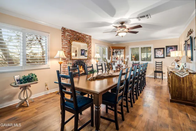 a living room with furniture kitchen view and a large window