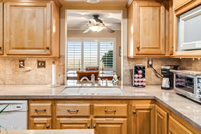 a living room with a floor to ceiling window and a table