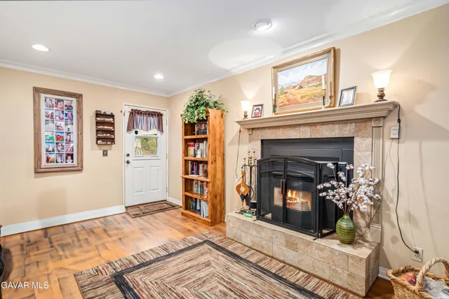 a living room with furniture kitchen view and a fireplace