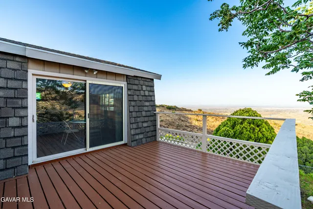 a front view of a house with a yard and potted plants