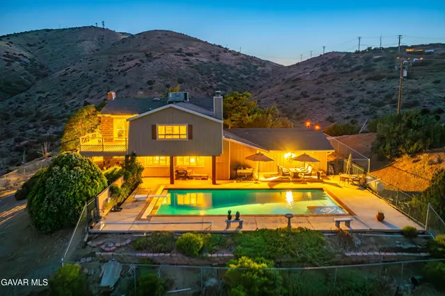 a view of a house with a yard and garage