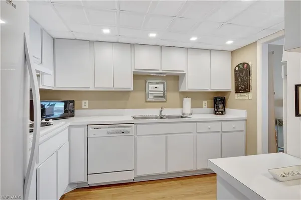 a kitchen with cabinets and window